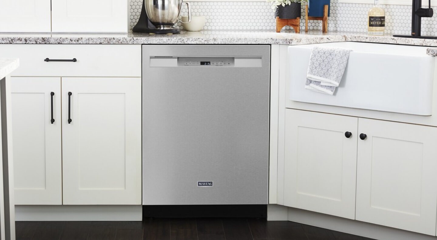 A Maytag® stainless steel dishwasher in a bright kitchen with white cabinetry
