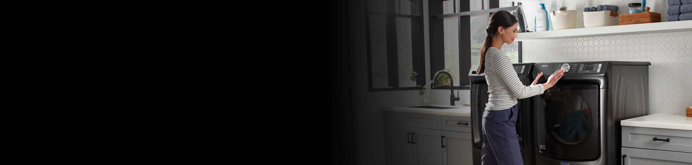 Person selecting a drying cycle on a Maytag® dryer