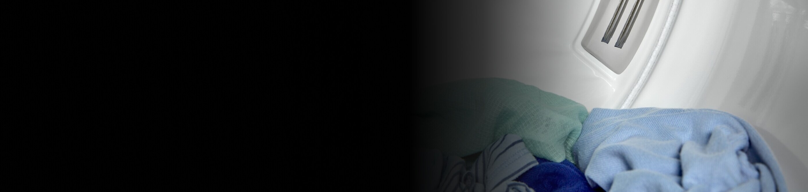 Close-up of dry clothes sitting inside a dryer drum