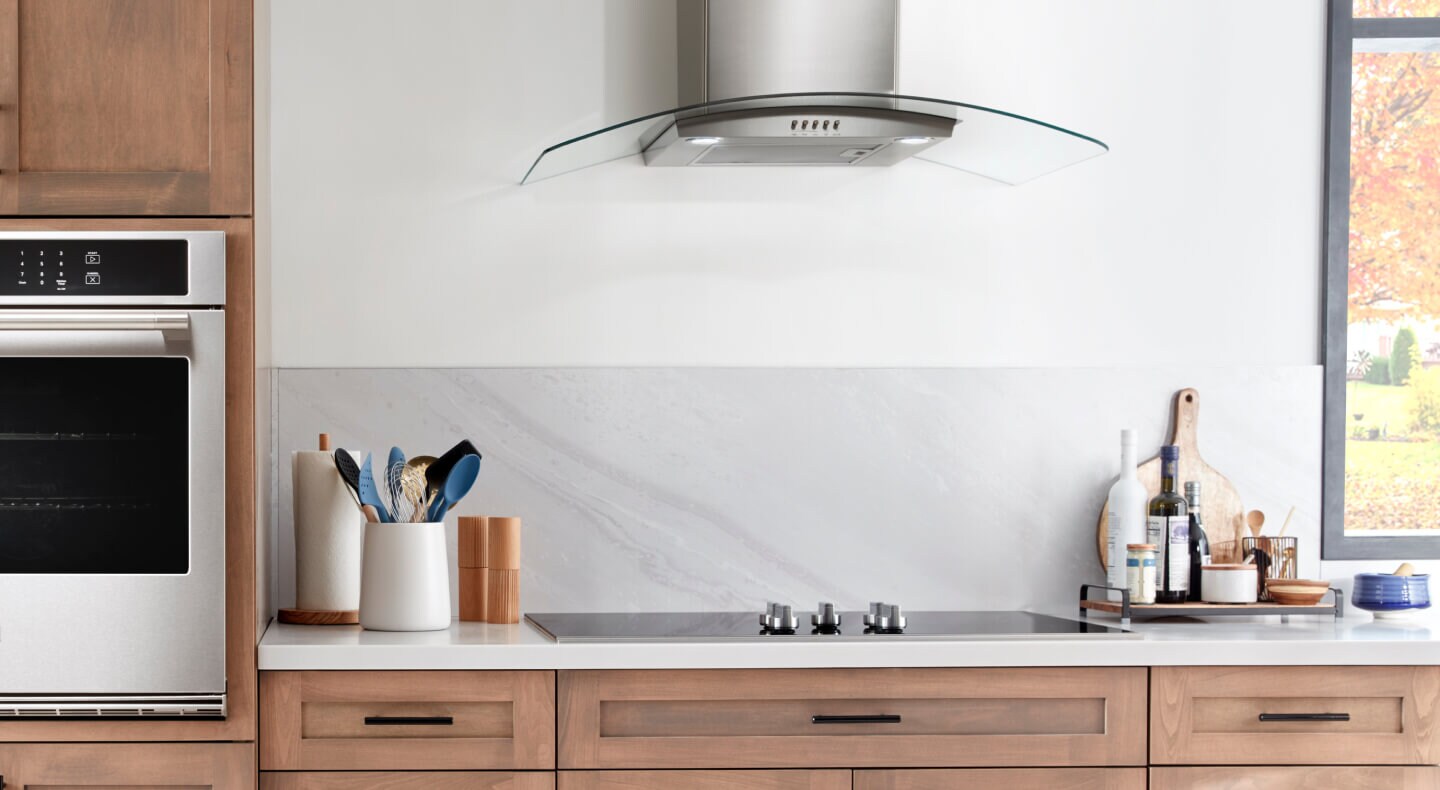 Maytag® electric cooktop installed above brown cabinetry