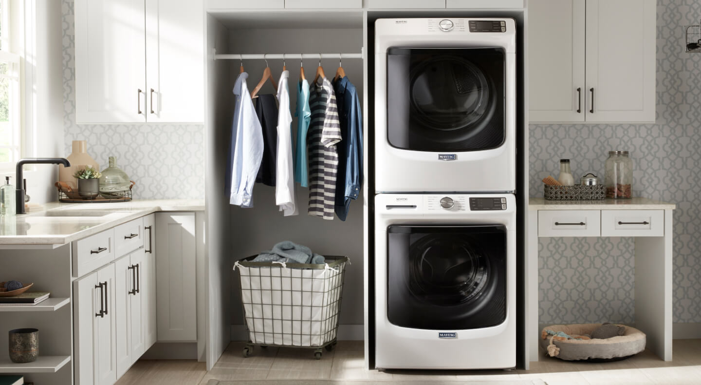 A stacking Maytag® washer and dryer laundry pair in a laundry room