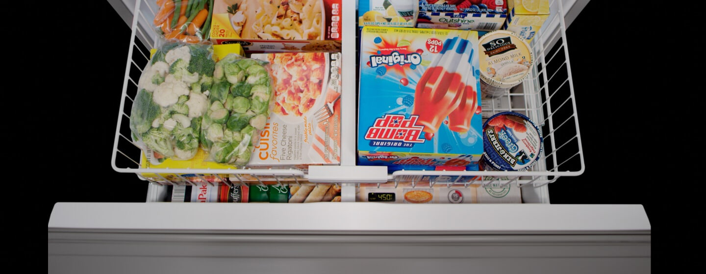Close up of an open freezer drawer Close up of an open freezer drawer