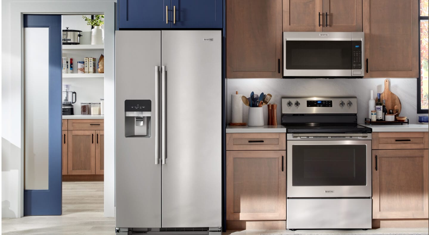 A stainless steel Maytag® side-by-side refrigerator in a modern kitchen