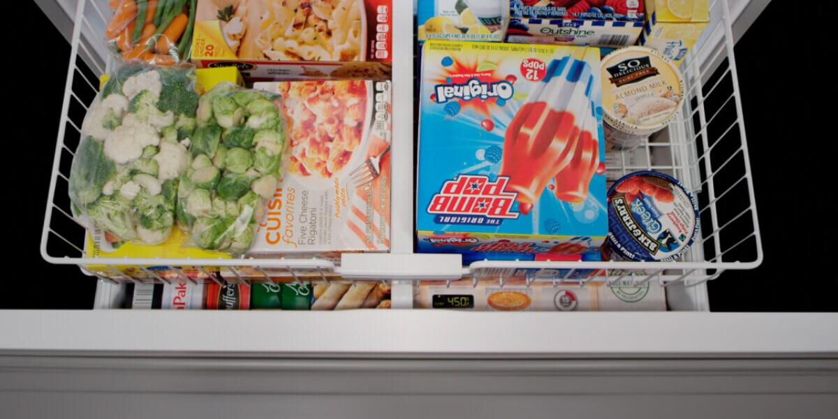 Close up of an open freezer drawer Close up of an open freezer drawer
