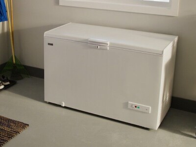 White Maytag brand chest freezer in a garage