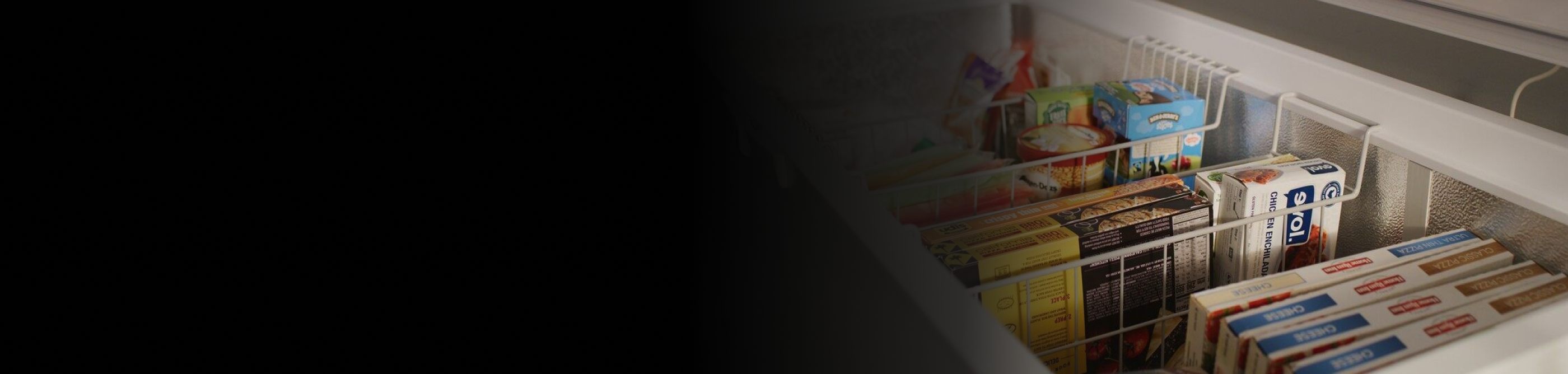 Close-up of chest freezer storage baskets full of food