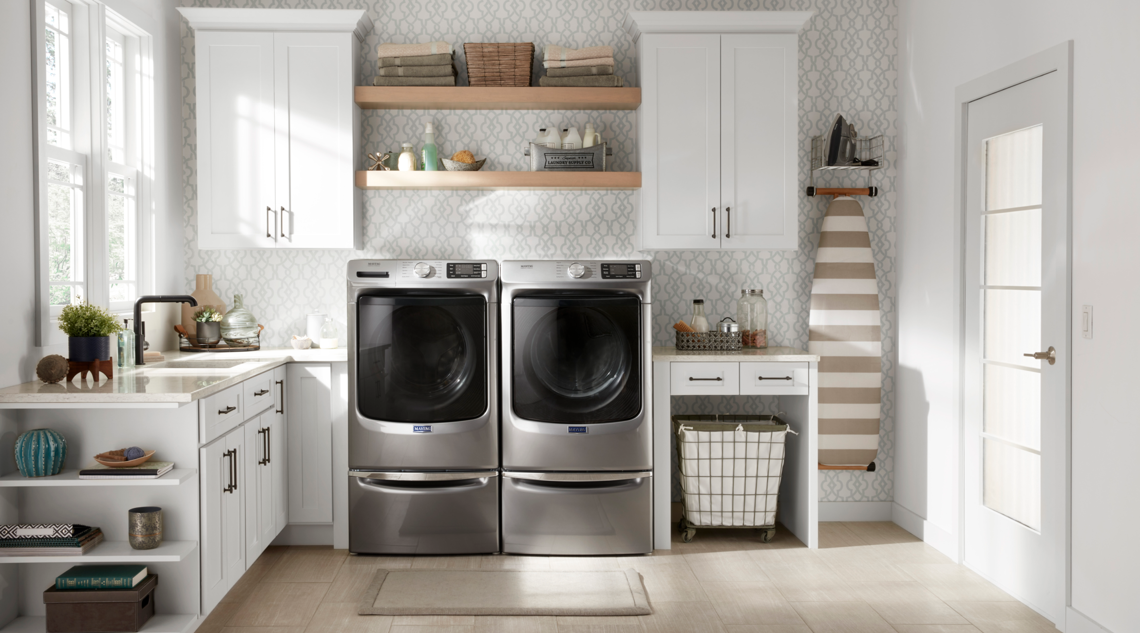  Maytag® front load washer and dryer set in a laundry room