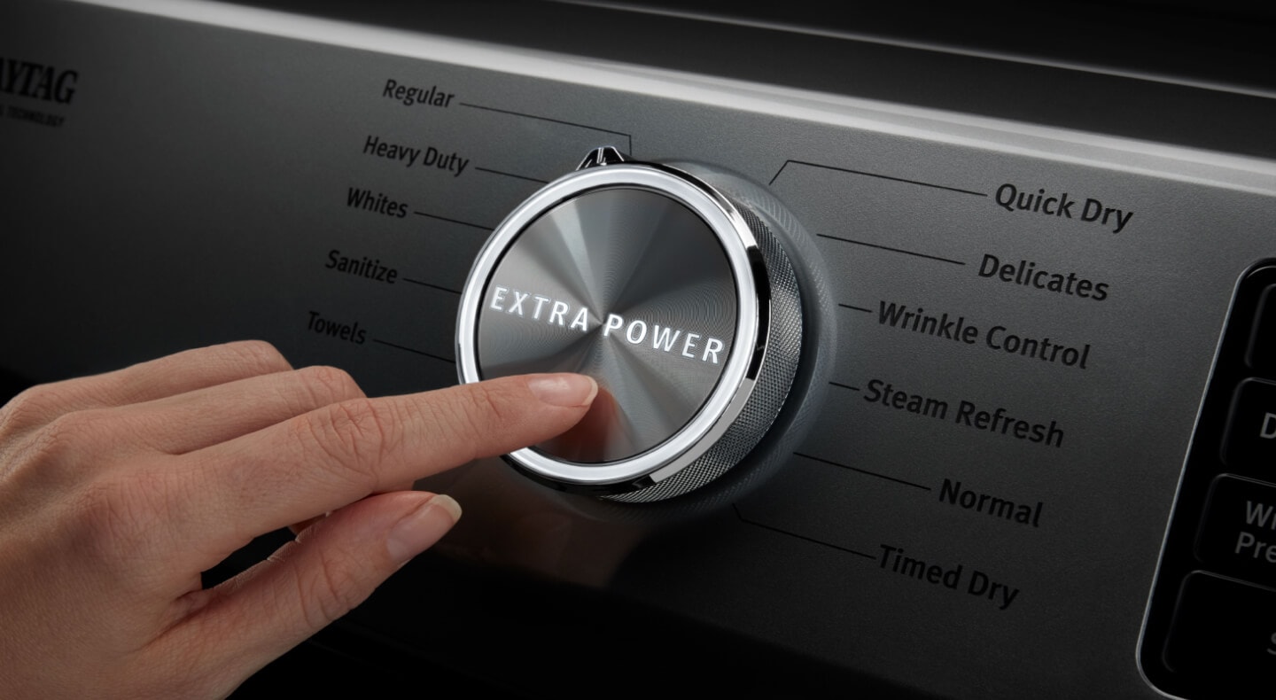 A person pressing the Extra Power button on a Maytag® dryer. A person pressing the Extra Power button on a Maytag® dryer.