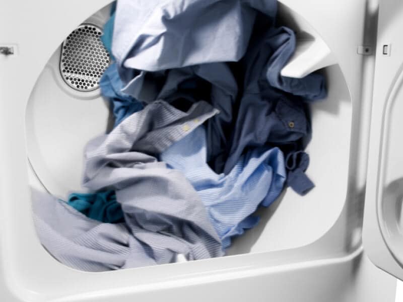 Blue clothes in a dryer.