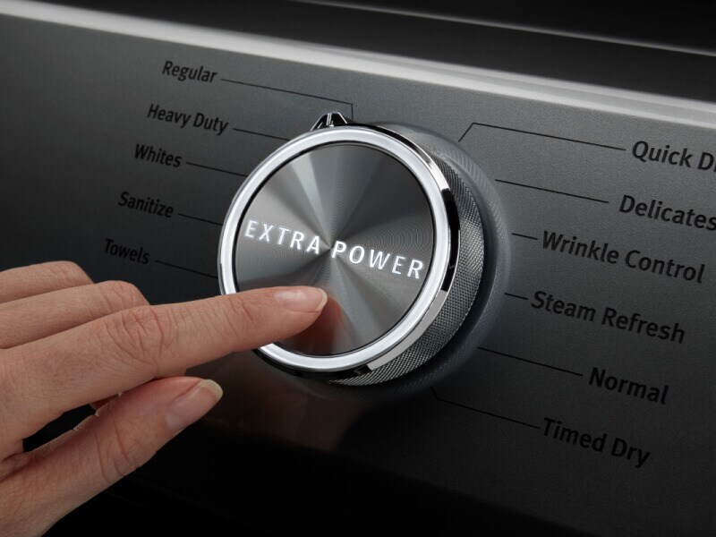 A person pressing the Extra Power button on a Maytag® dryer. A person pressing the Extra Power button on a Maytag® dryer.