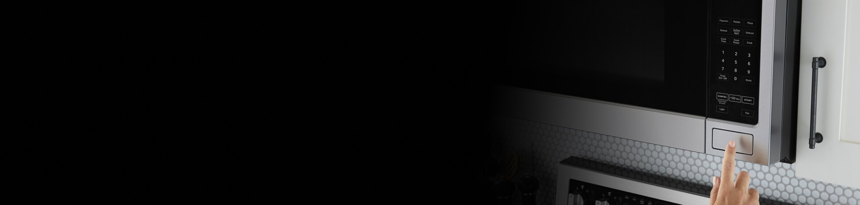 Hand opening an over-the-range microwave