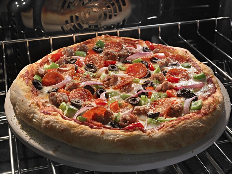 Close-up shot of pizza baking on the top sheet of an oven. Close-up shot of pizza baking on the top sheet of an oven.