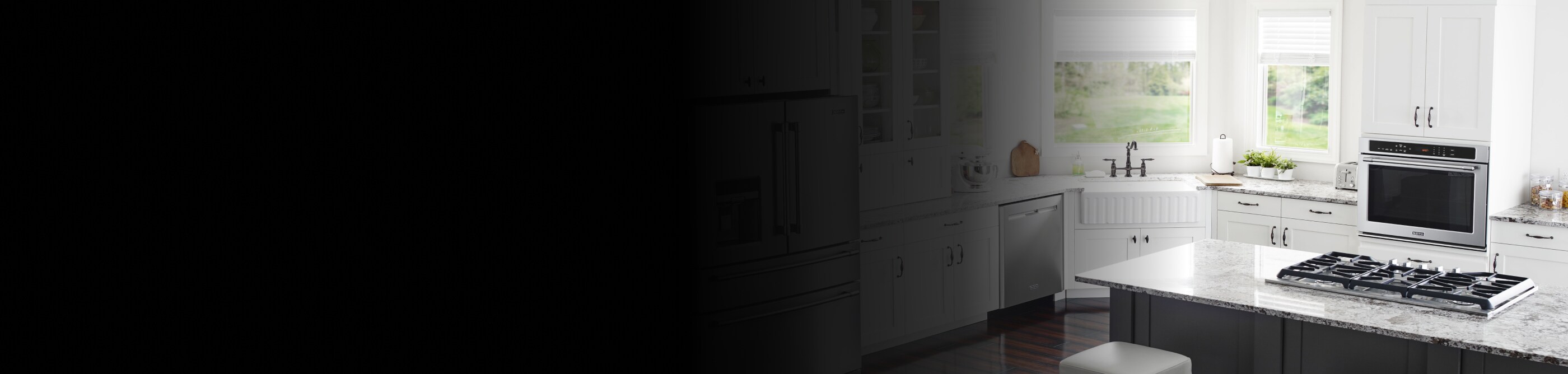 Interior overview of kitchen with gas range and wall oven.