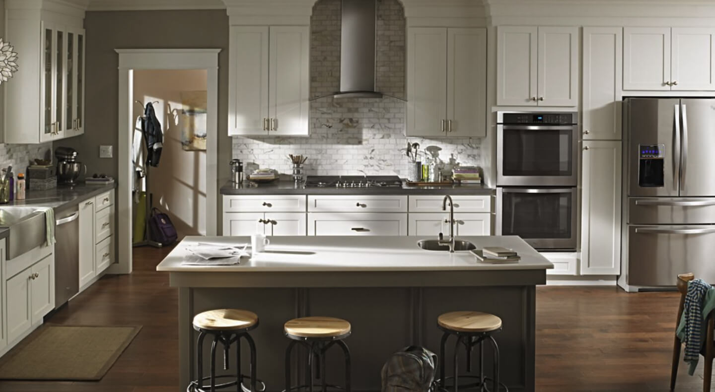 Wall mount range hood in kitchen with stainless steel appliances Wall mount range hood in kitchen with stainless steel appliances
