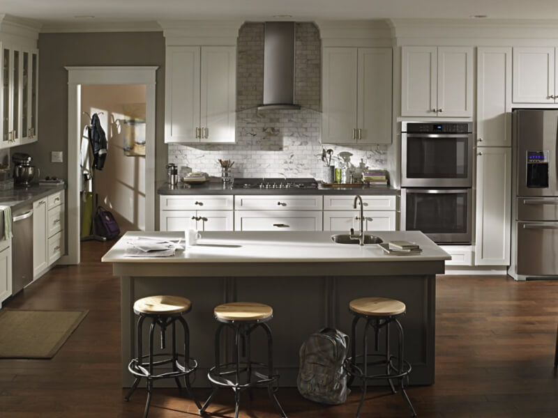 Wall mount range hood in kitchen with stainless steel appliances Wall mount range hood in kitchen with stainless steel appliances