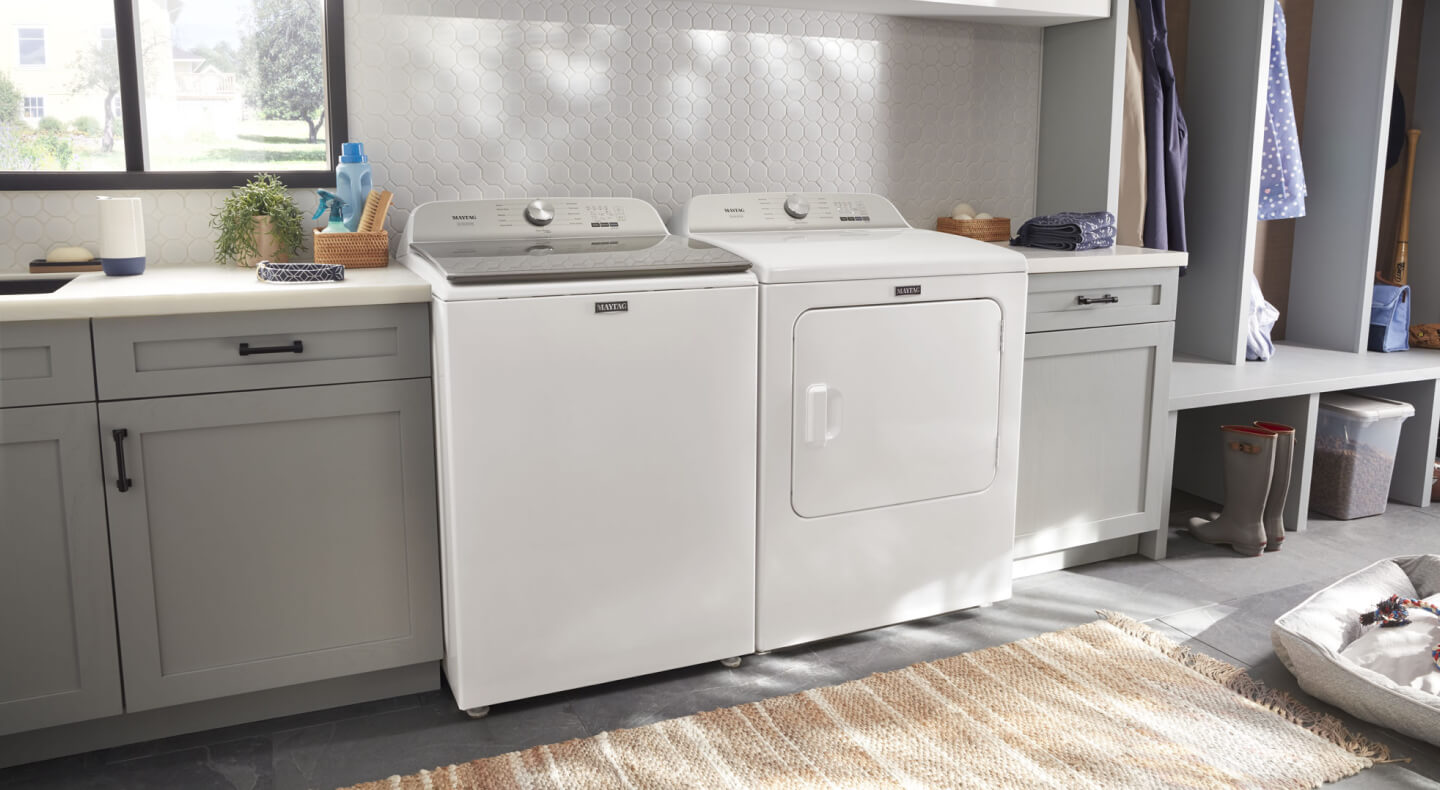 A side-by-side Maytag® washer and dryer in a modern laundry room