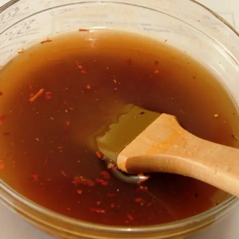  Basting brush inside a bowl of gravy mixture