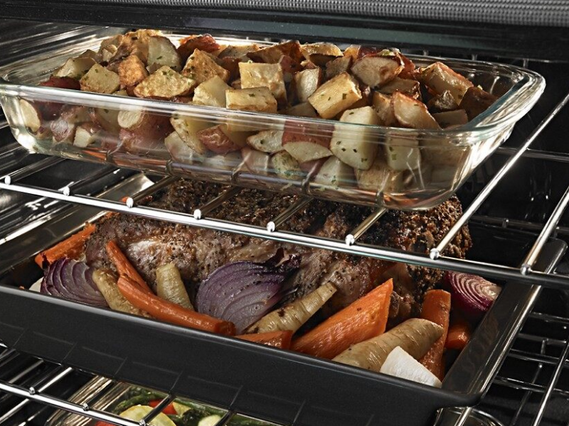 Three dishes on different racks in the oven