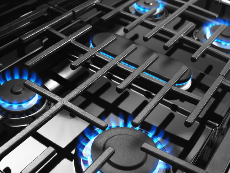 Close-up of the blue flame of gas stovetop elements