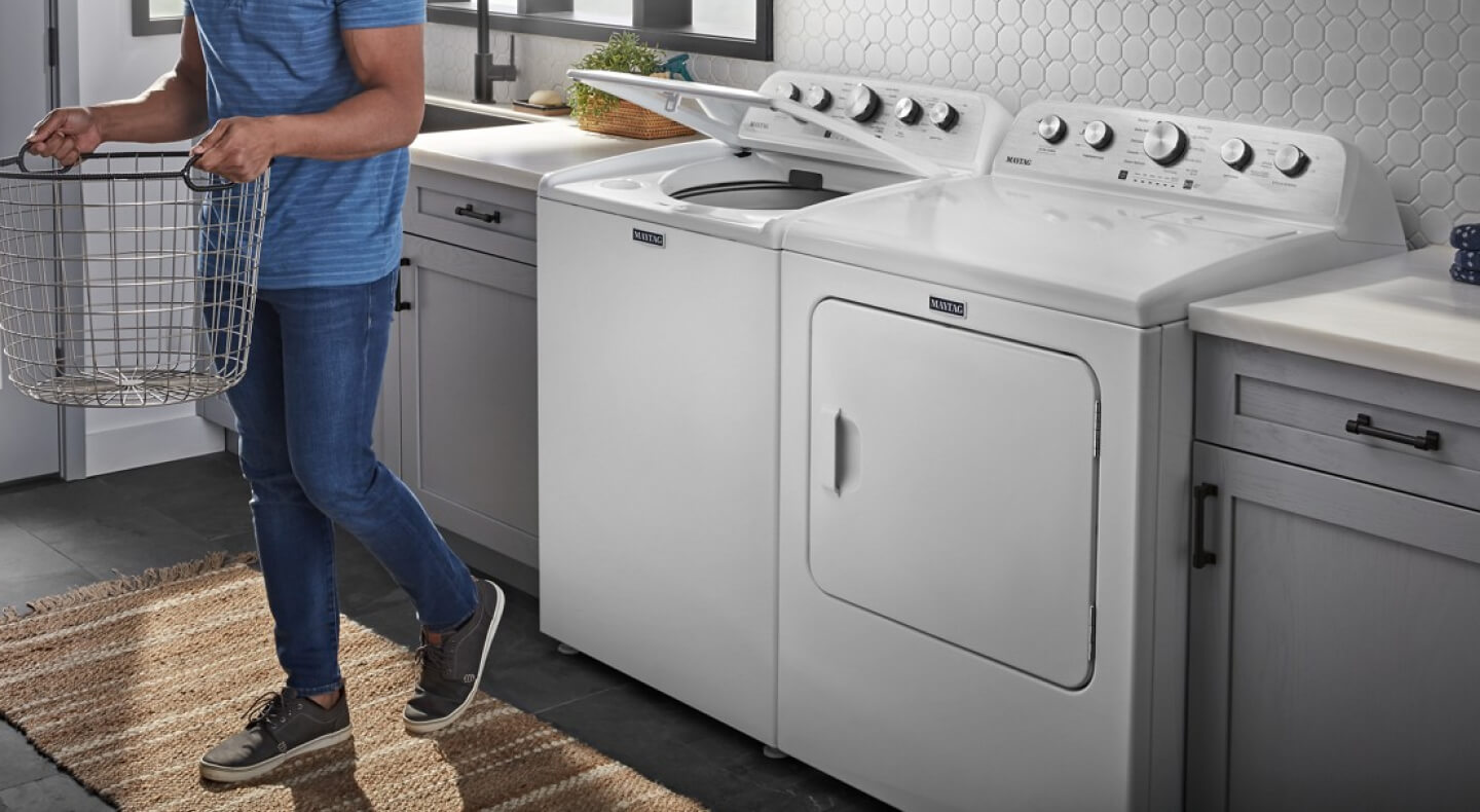 White Maytag® top load laundry pair in laundry room