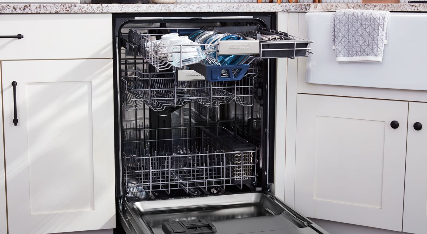 Open Maytag® dishwasher with dishes on the top rack Open Maytag® dishwasher with dishes on the top rack