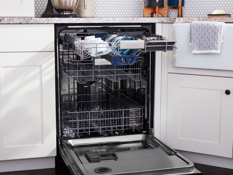 Open Maytag® dishwasher with dishes on the top rack Open Maytag® dishwasher with dishes on the top rack