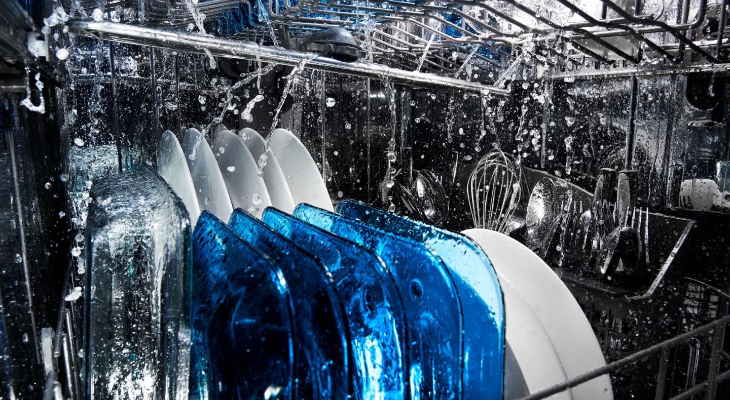 Dishes being run through a dishwasher wash cycle Dishes being run through a dishwasher wash cycle