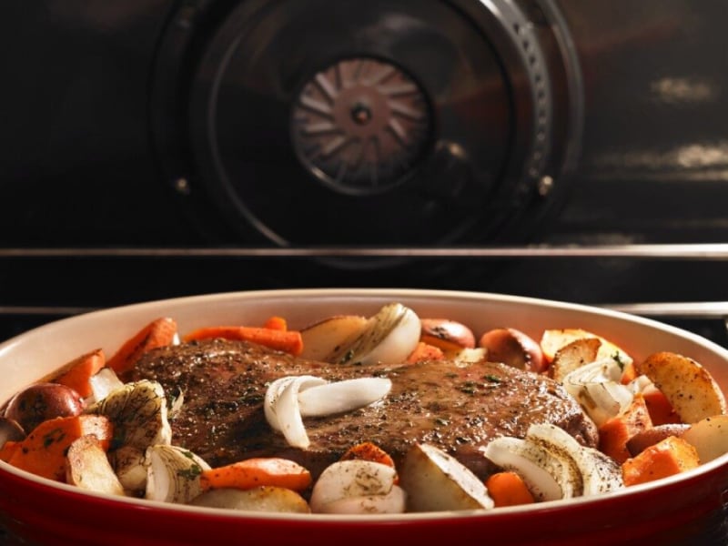 Pot roast and vegetables cooking inside a Maytag® oven