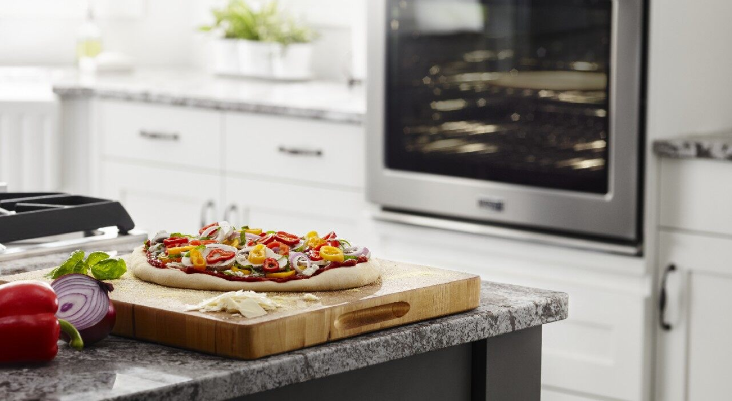Homemade pizza on a wooden cutting board