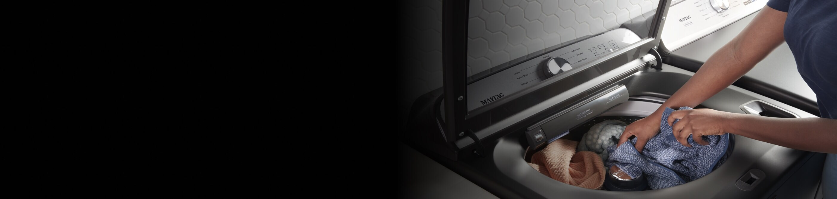 A person loading clothing into a Maytag® washing machine