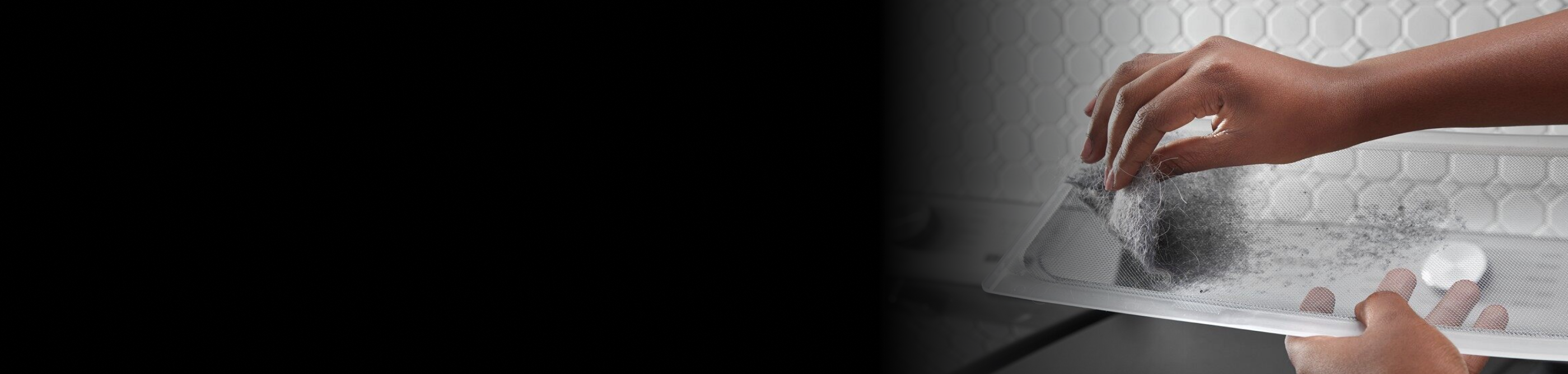 Person removing lint from a lint trap