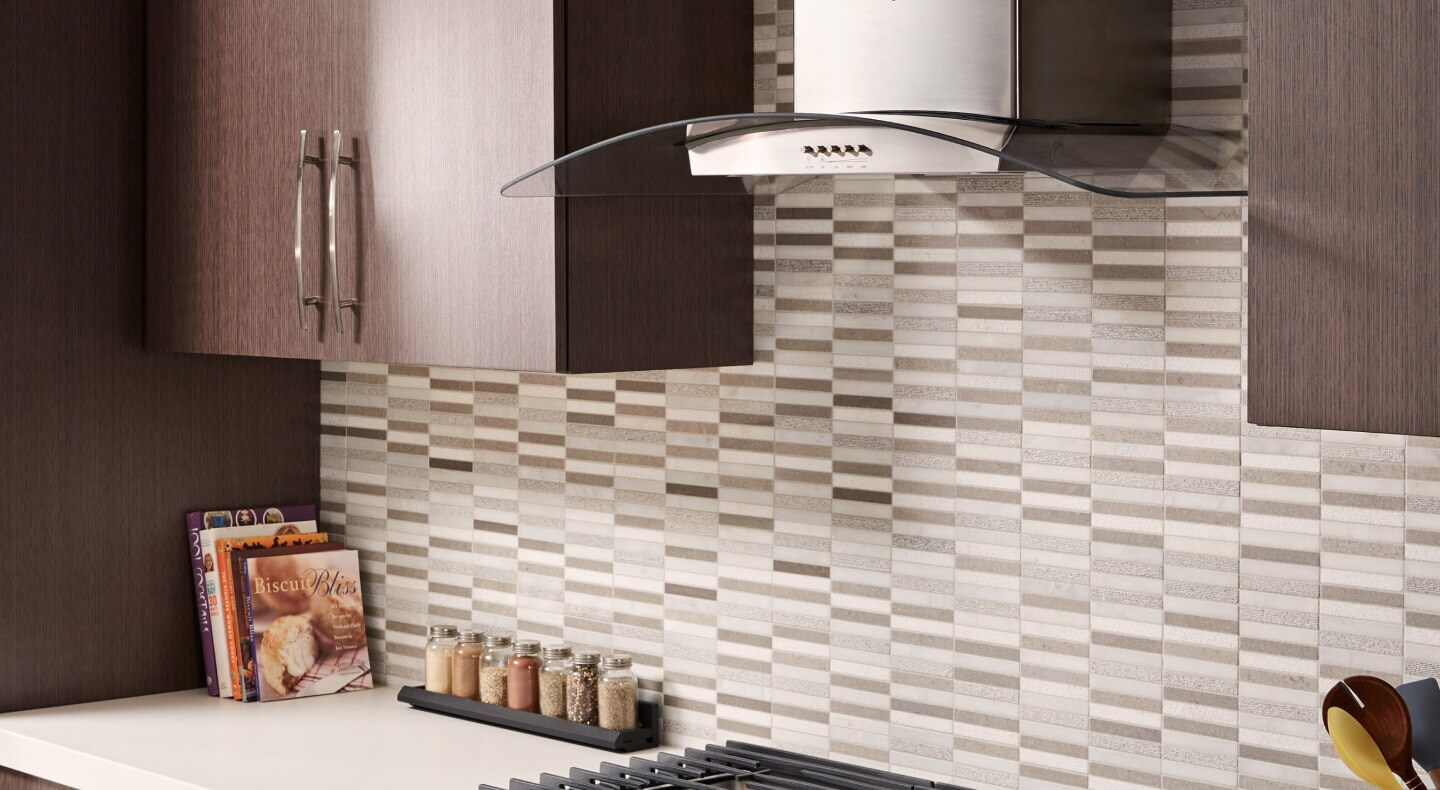 Glass wall mount range hood in a modern kitchen