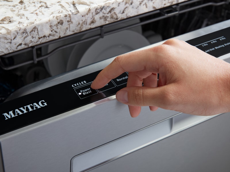 Person selecting the PowerBlast® cycle on a Maytag® dishwasher Person selecting the PowerBlast® cycle on a Maytag® dishwasher