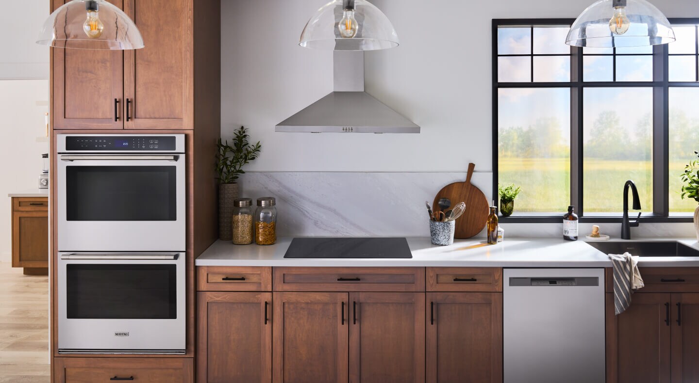 A bright kitchen with stainless appliances and an induction cooktop