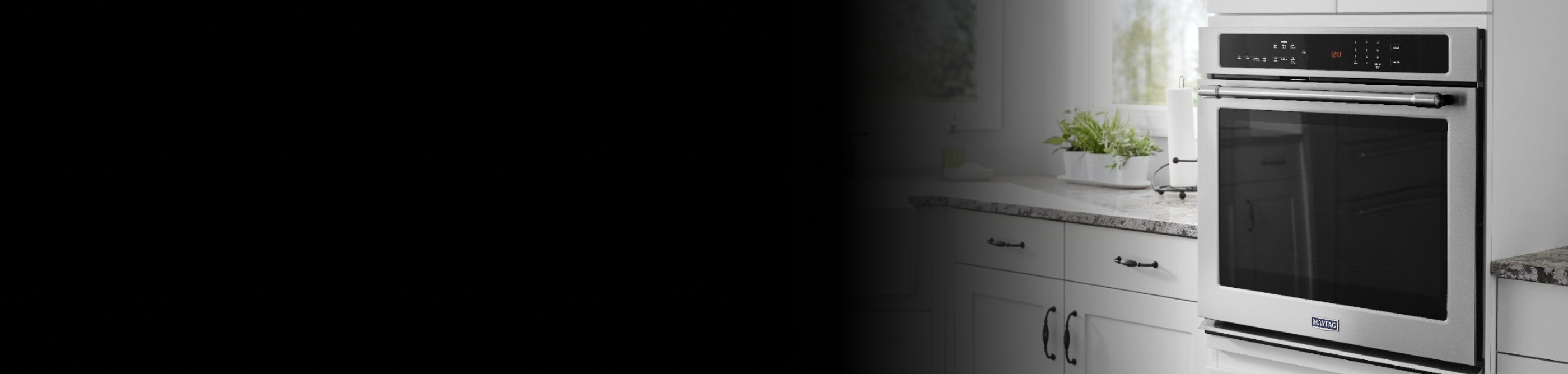 Maytag® wall oven set in white cabinetry