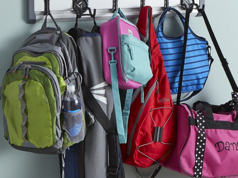 A closeup of a coat rack bags and backpacks. A closeup of a coat rack bags and backpacks.