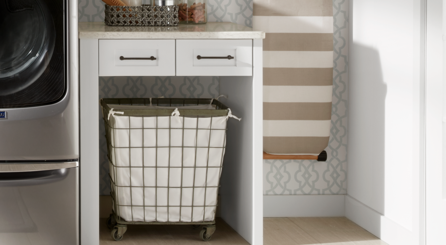 A laundry basket next to a Maytag® dryer in a modern laundry room. A laundry basket next to a Maytag® dryer in a modern laundry room.