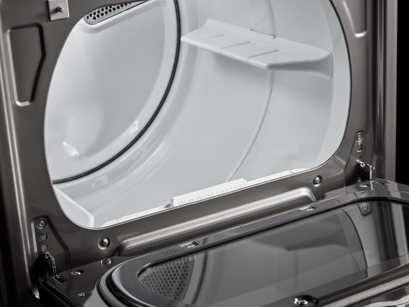 White interior dryer drum of a front load dryer White interior dryer drum of a front load dryer