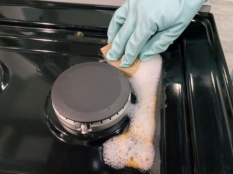 Removing grease from stovetop with soapy water