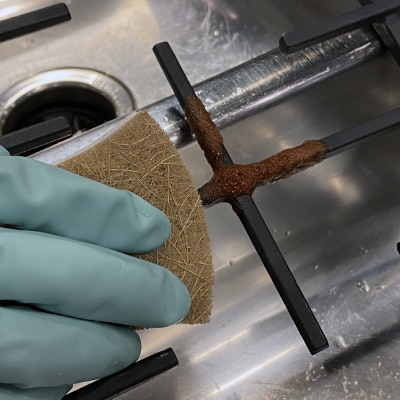 Scrubbing pasta sauce off grates