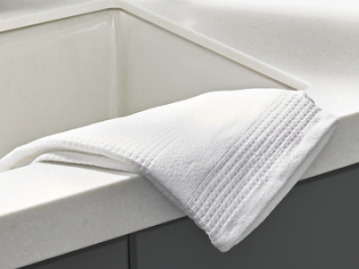 Towel laying on the edge of a kitchen sink