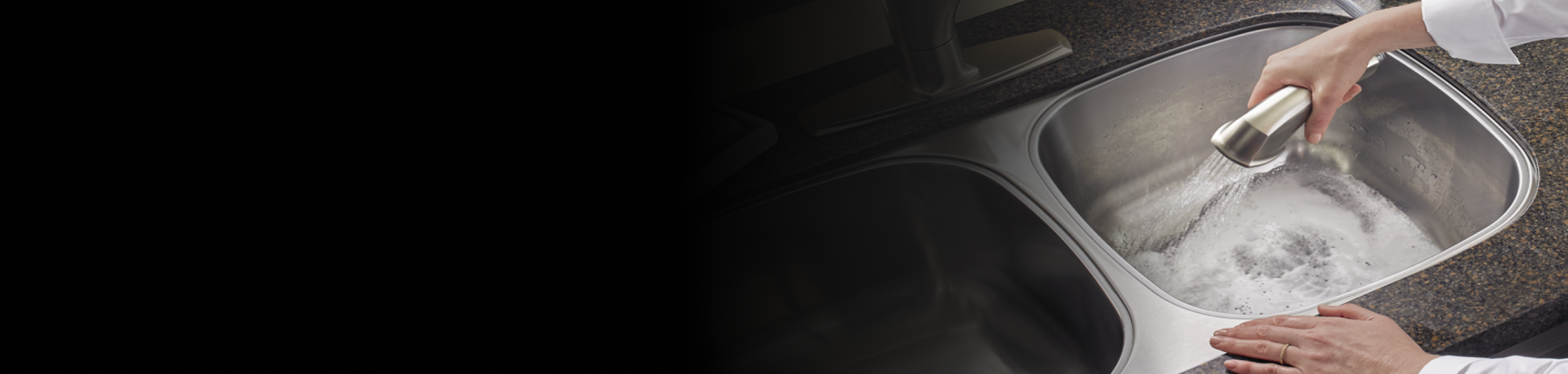 Person rinsing kitchen sink