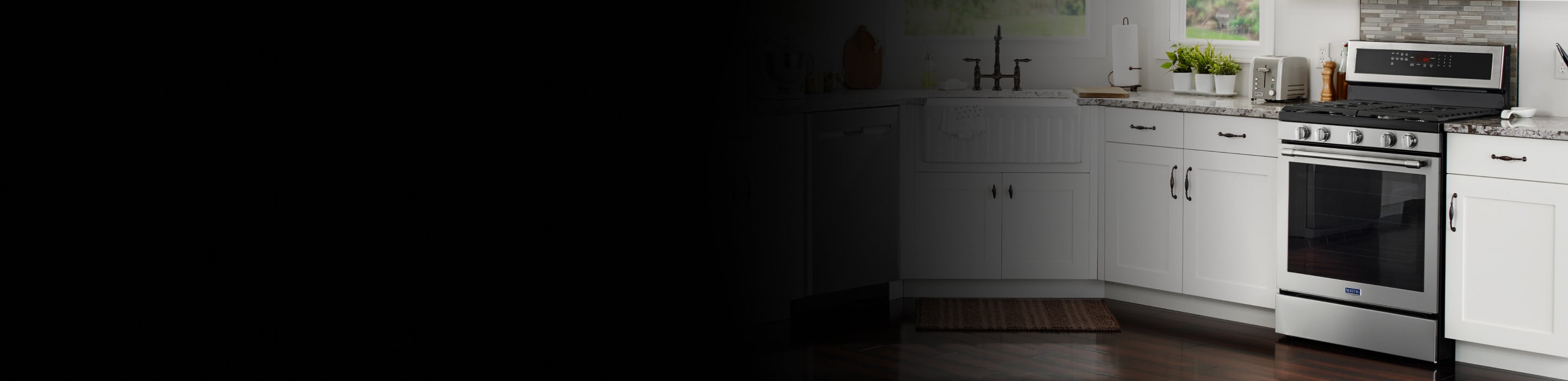 Maytag stainless steel oven set between white cabinets