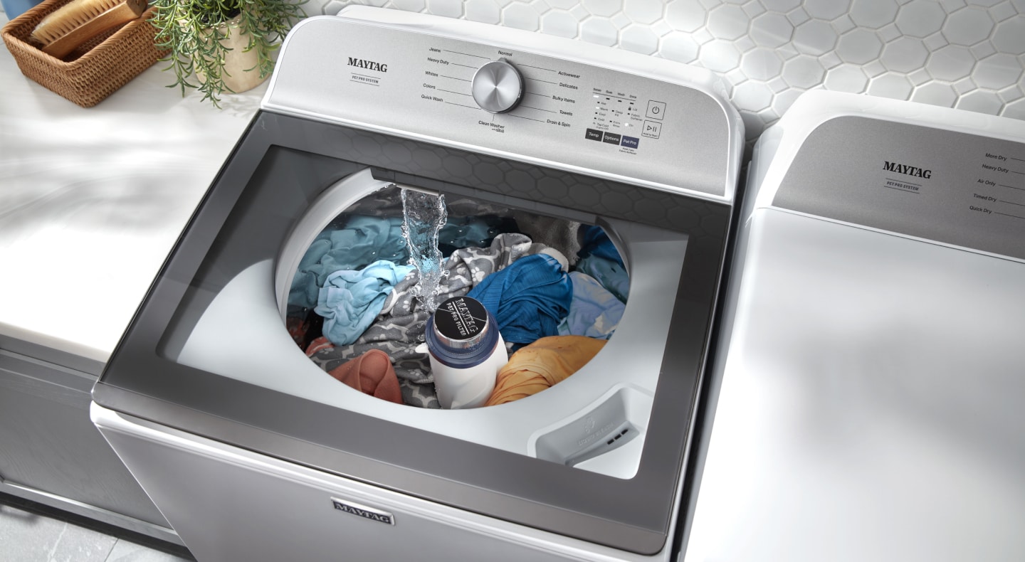 Clothes inside a white Maytag® top load washer Clothes inside a white Maytag® top load washer