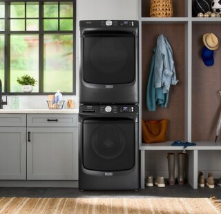 Stacked front load washer and dryer in a laundry room