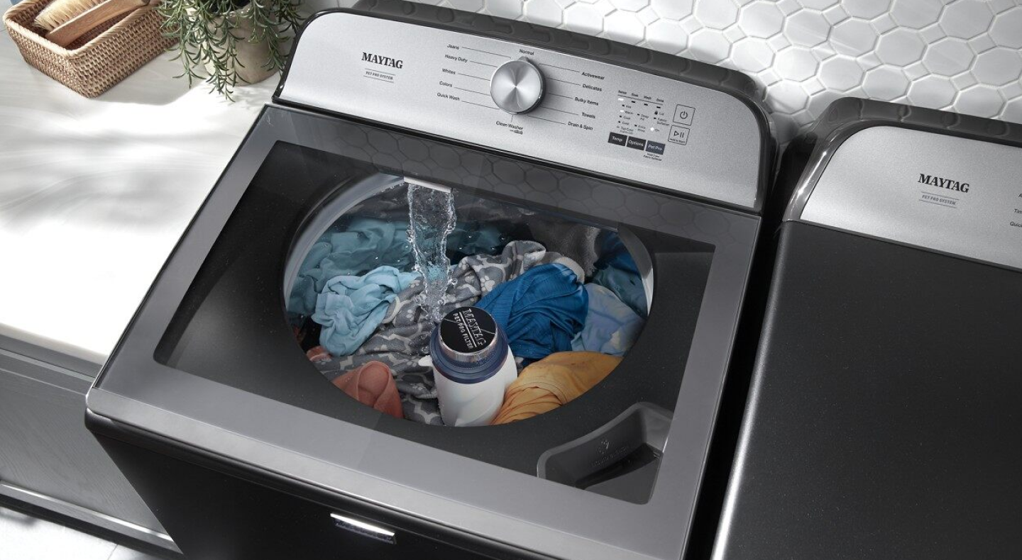 Overhead view of top-load washer filled with laundry