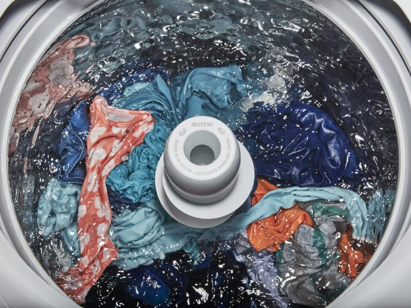 Tight overhead shot of top-load washer mid cycle