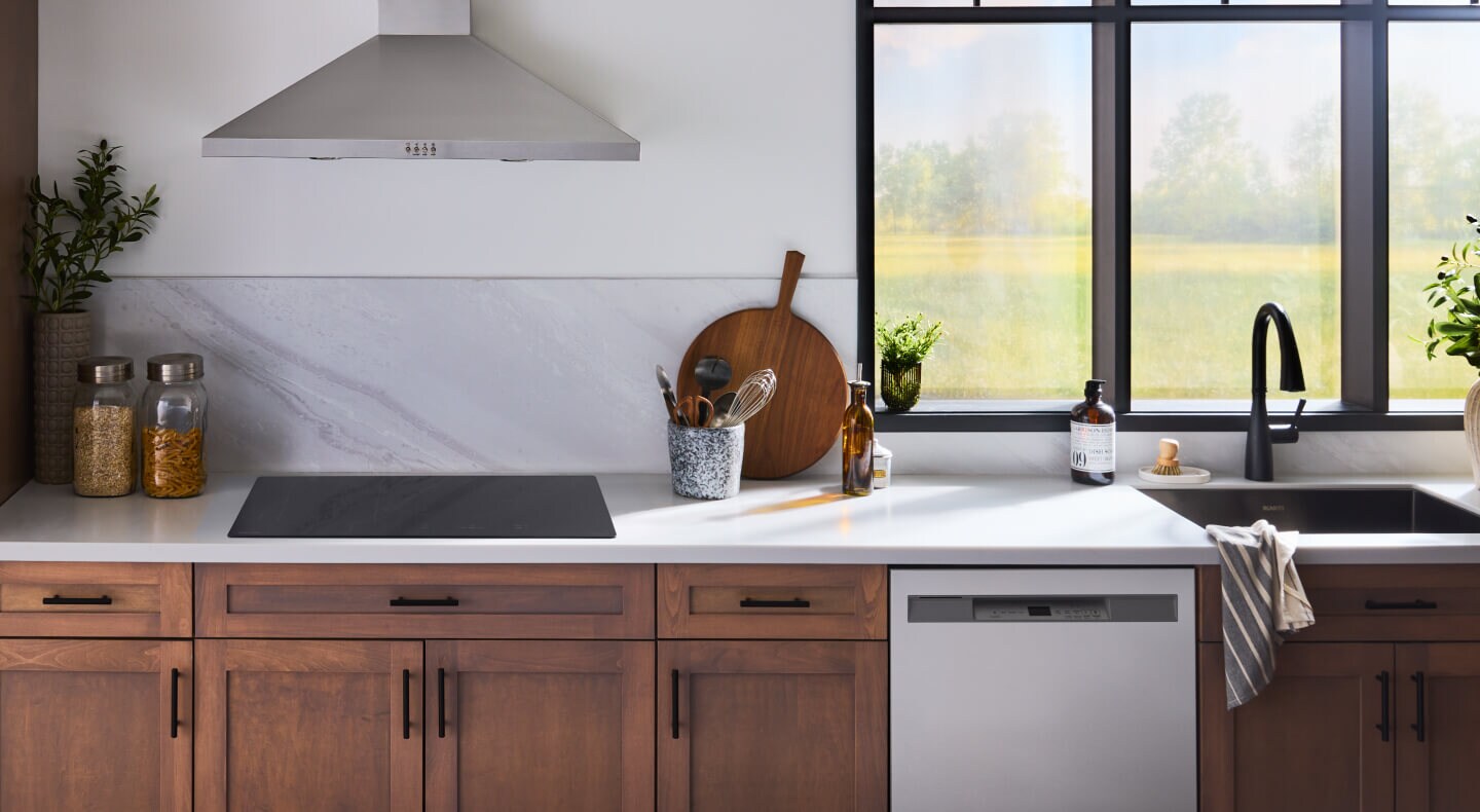 Modern kitchen with brown cabinetry and an electric cooktop