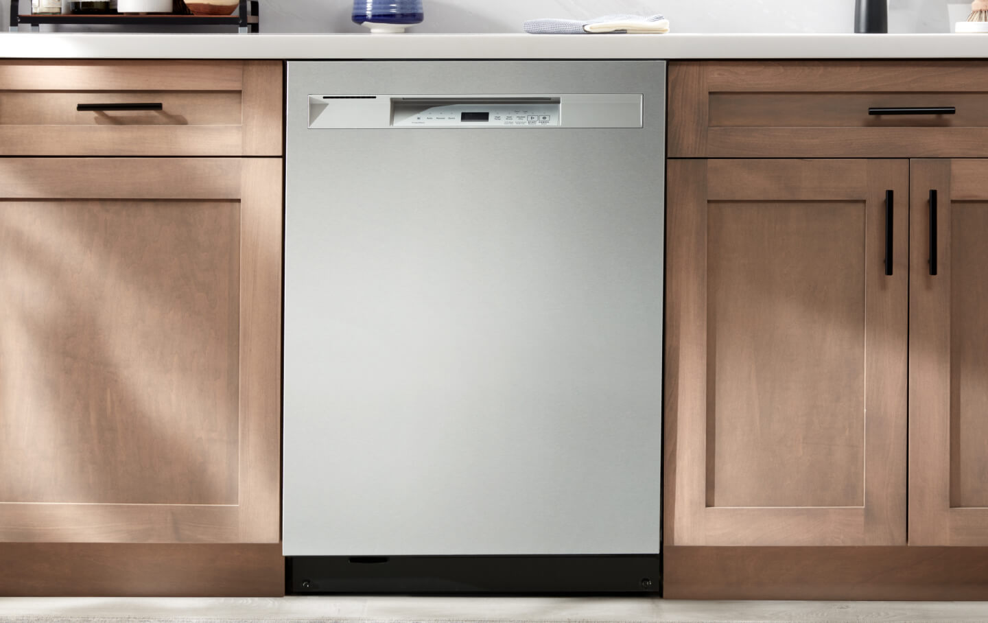 A Maytag® dishwasher installed flush against kitchen cabinets and countertops