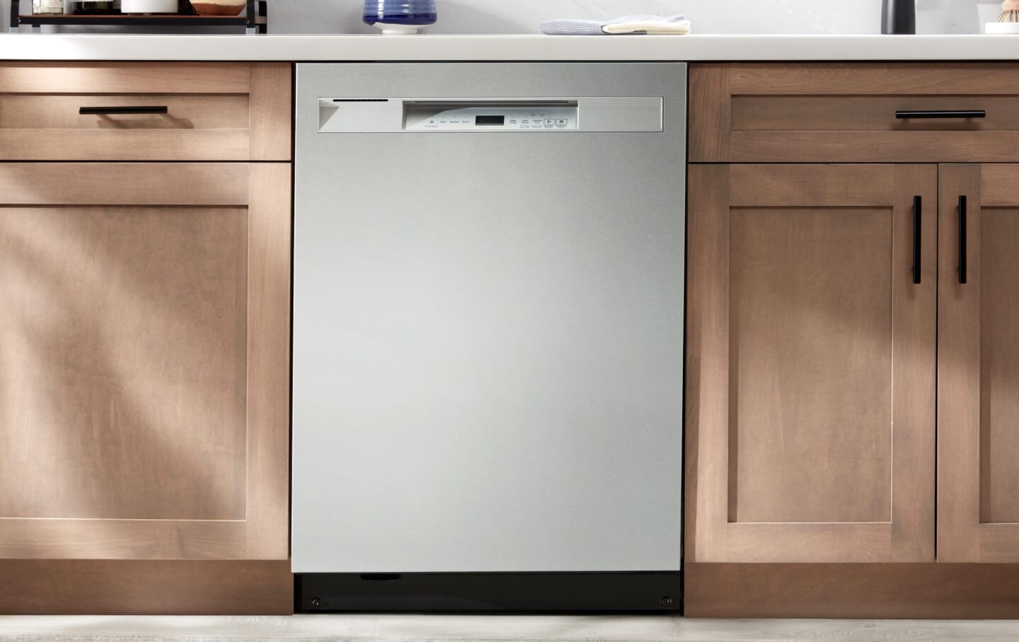 A Maytag® dishwasher installed flush against kitchen cabinets and countertops